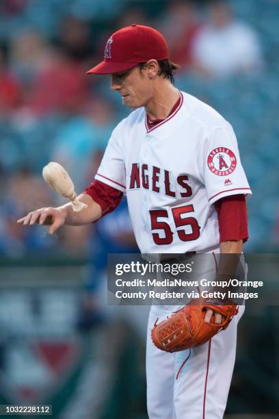 The Angels' Tim Lincecum gets some rosin while pitching against the Texas Rangers at Angel Stadium on Tuesday. ///ADDITIONAL INFO: angels.0720.kjs...