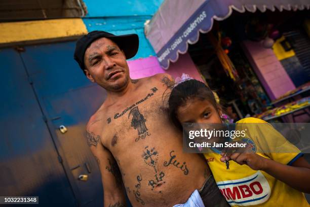 Mexiacn girl shows a protective Santa Muerte amulet during a religious pilgrimage on April 1, 2018 in Tepito, Mexico City, Mexico. Santa Muerte is a...