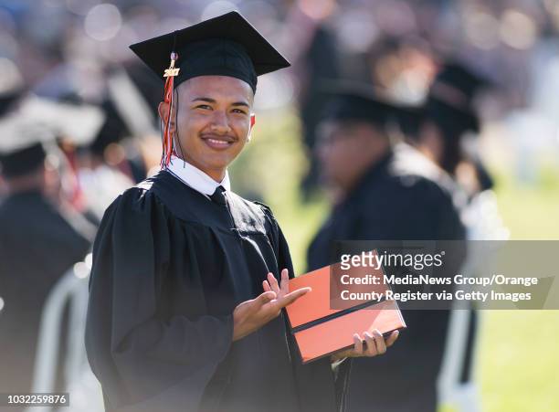 Graduate Aaron Lopez shows off his empty diploma book during the Los Amigos High School Graduation at Bolsa Grande Stadium in Garden Grove, CA on...