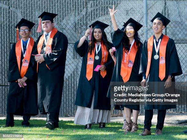 Graduates wave to friends and family before the Los Amigos High School Graduation at Bolsa Grande Stadium in Garden Grove, CA on Tuesday, June 20,...