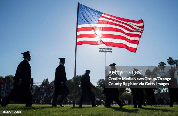 Graduates file off the field after the Los Amigos High School Graduation at Bolsa Grande Stadium in Garden Grove, CA on Tuesday, June 20, 2017.