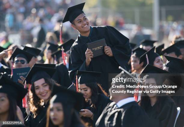 Graduate shows off his diploma cover during the Los Amigos High School Graduation at Bolsa Grande Stadium in Garden Grove, CA on Tuesday, June 20,...
