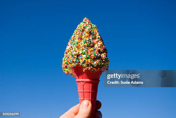 icecream cone with blue sky - ice cream sprinkles stock pictures, royalty-free photos & images