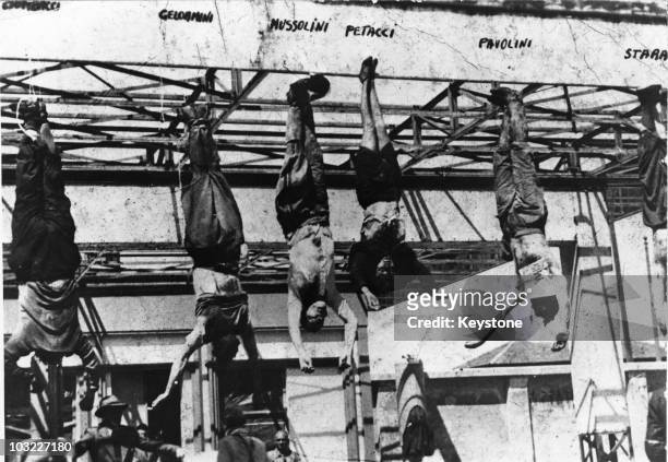 The corpse of Italian fascist leader Benito Mussolini hangs by his feet at a petrol station in Milan, after his execution by partisans at Mezzegra,...
