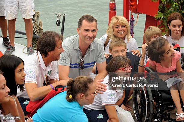 Prince Felipe of Spain pose with "Alex y Rubio Rumbo a Ti" foundation members during the 29th Copa del Rey Mapfre Audi Sailing Cup on August 4, 2010...