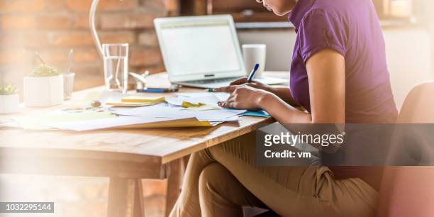 young woman working late - legs crossed at knee stock pictures, royalty-free photos & images
