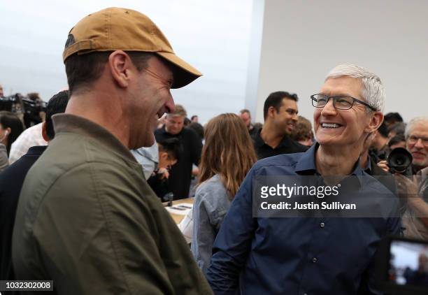 Apple CEO Tim Cook laughs with actor Jon Hamm during an Apple special event at the Steve Jobs Theatre on September 12, 2018 in Cupertino, California....