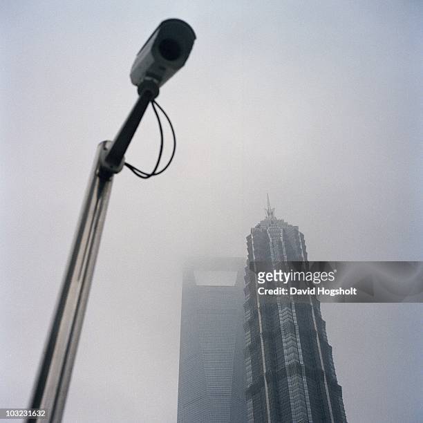 Camera is seen in front of Shanghai World Financial Center and Jin Mao Tower in the financial district of Lujiazui in Pudong July 15, 2010 in...