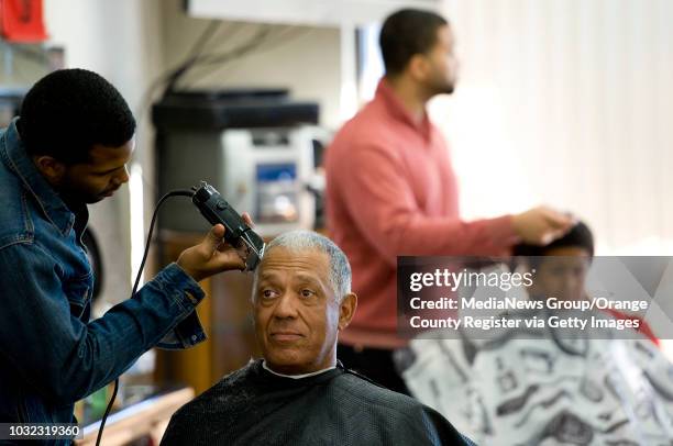 Ray Burley gets his hair cut by barber Matt Neville, left, at Pierre Dotson's A-Unique Barbershop in Anaheim Saturday afternoon. ///ADDITIONAL INFO:...