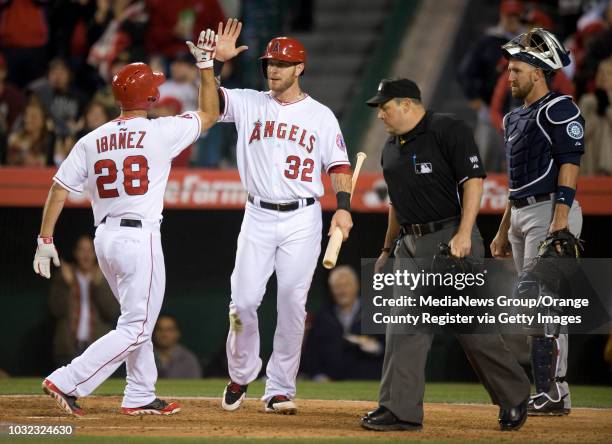 The Angels' Josh Hamilton greets Raul Ibanez after his two-run homer in the fourth inning against the Seattle Mariners Tuesday night at Angel...