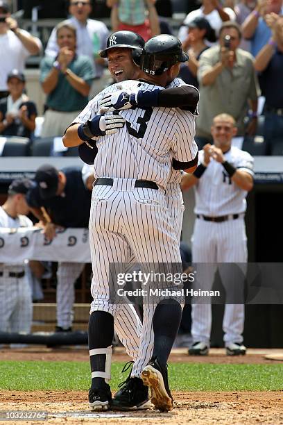 Alex Rodriguez of the New York Yankees celebrates with teammate Derek Jeter after hitting the 600th home run of his career in the first inning as...