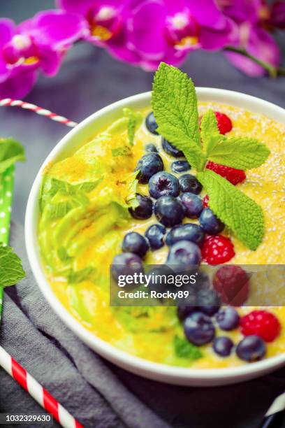 turmeric smoothie buddha bowl - avocado smoothie stock pictures, royalty-free photos & images