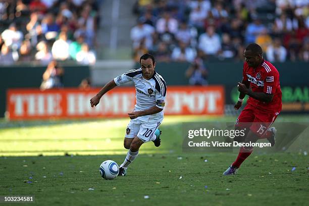 Landon Donovan of the Los Angeles Galaxy paces the ball on the attack under pressure from Collins John of the Chicago Fire during their MLS match at...