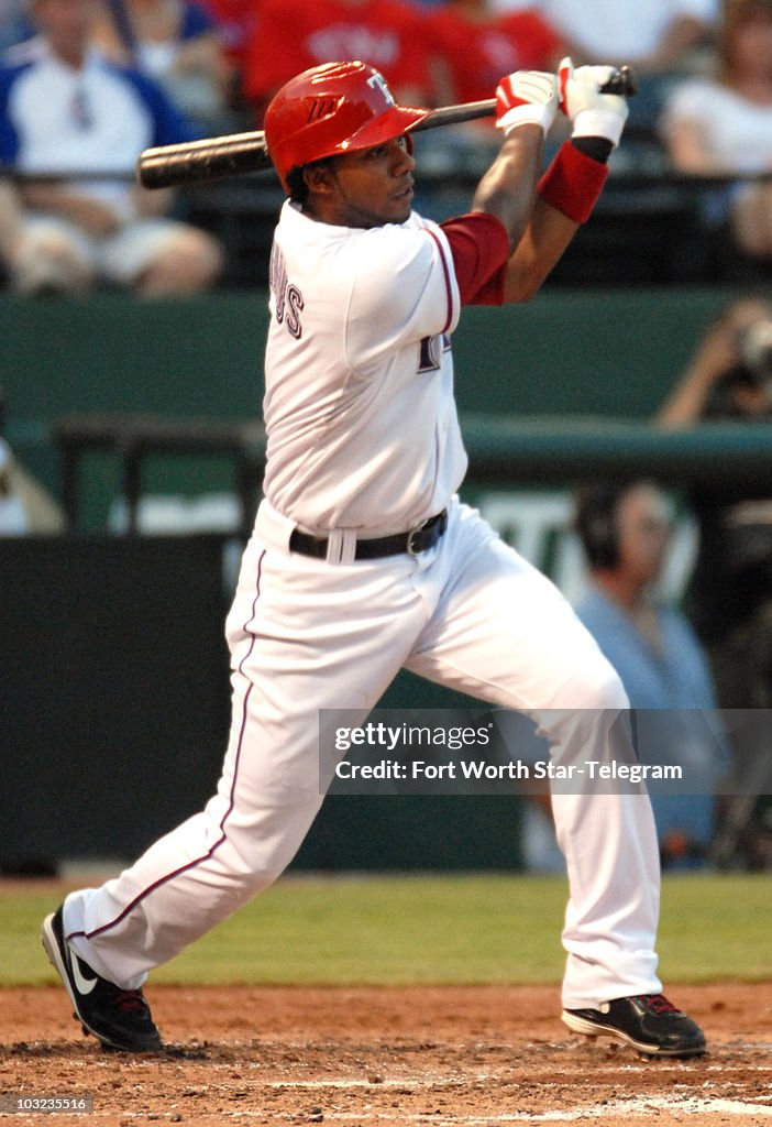 Texas Rangers Andrus Texas Rangers' TElvis Andrus follows through on an RBI hit in the ...