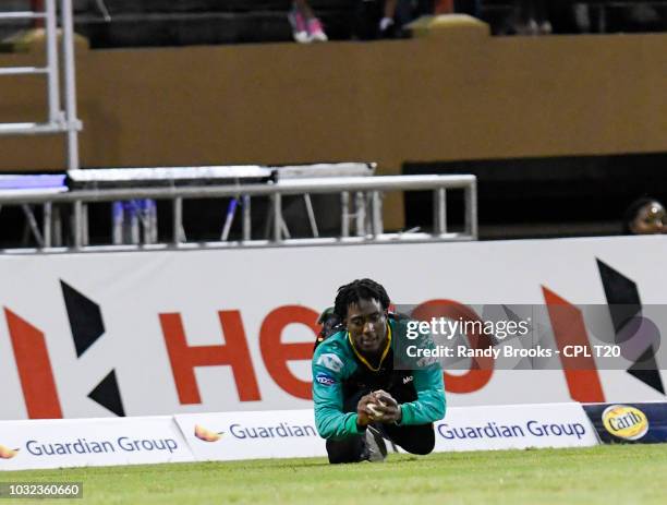 In this handout image provided by CPL T20, Hayden Walsh Jr. Of St Kitts & Nevis Patriots takes the catch to dismiss Andre Russell of Jamaica...