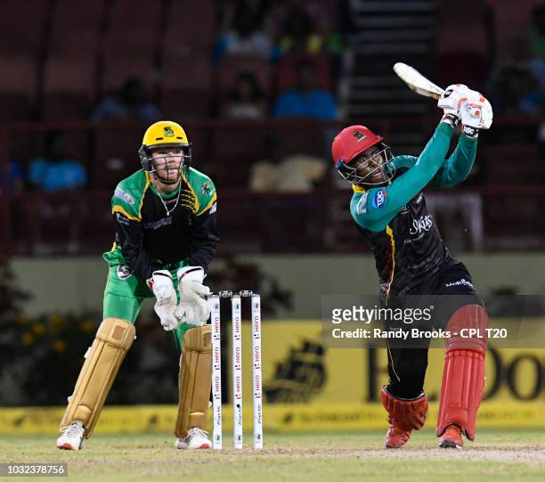 In this handout image provided by CPL T20, Fabian Allen hits 6 and Glenn Phillips of St Kitts & Nevis Patriots of Jamaica Tallawahs watch during the...