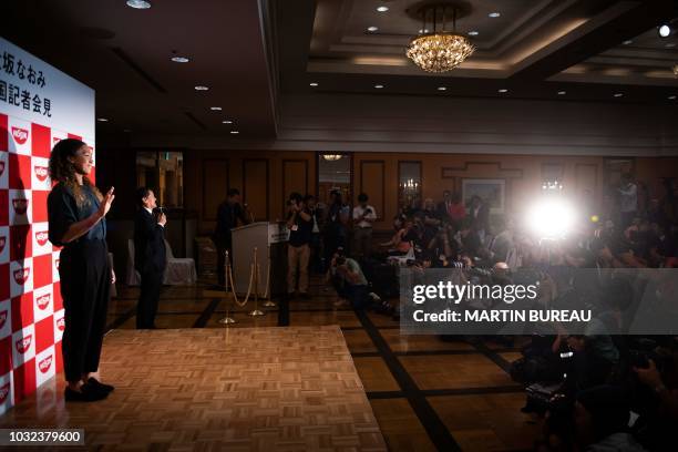 Japan's Naomi Osaka, the US Open women's singles tennis tournament champion, attends a press conference at a hotel in Yokohama on September 13, 2018.