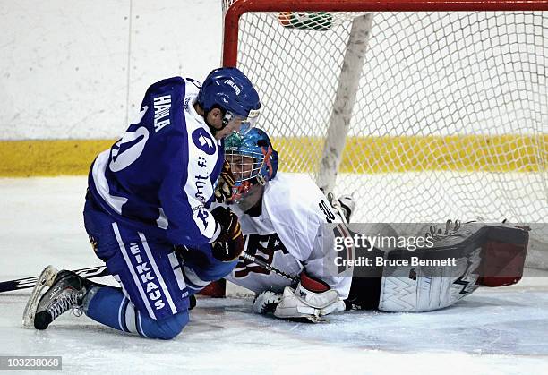 Andy Iles of Team USA makes the stop on Erik Haula of Team Finland at the USA Hockey National Evaluation Camp on August 4, 2010 in Lake Placid, New...