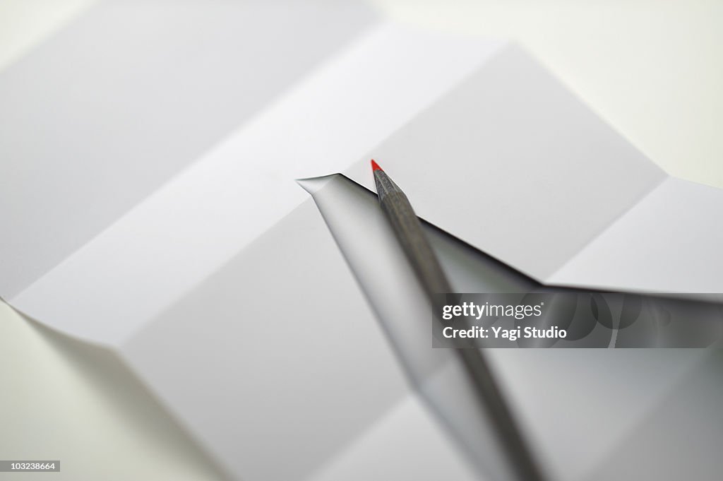 The paper which a red pencil and a cone were writt