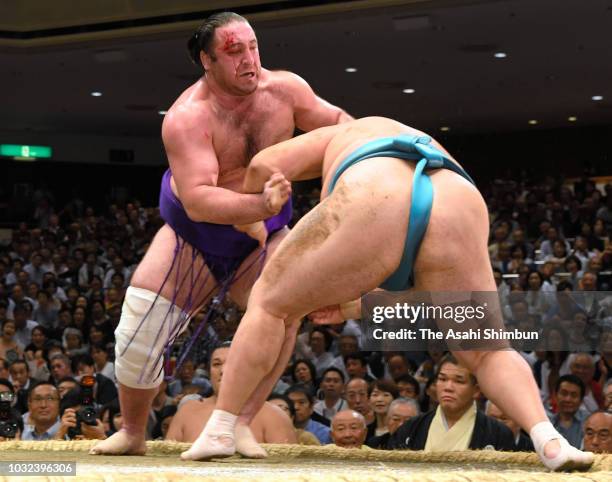 Ozeki Tochinoshin throws Mongolian komusubi Tamawashi to win on day four of the Grand Sumo Autumn Tournament at Ryogoku Kokugikan on September 12,...