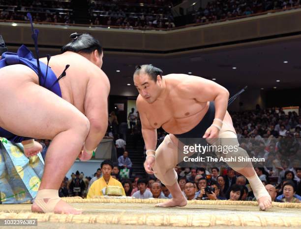 Aminishiki and Mongolian wrestler Daishoho compete in the juryo rank bout on day four of the Grand Sumo Autumn Tournament at Ryogoku Kokugikan on...