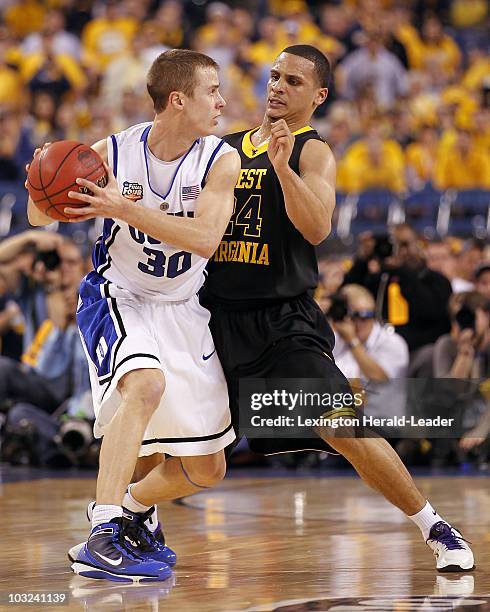 Joe Mazzulla of West Virginia guards Jon Scheyer of Duke in the first half of an NCAA Final Four semifinal game at Lucas Oil Stadium in Indianapolis,...