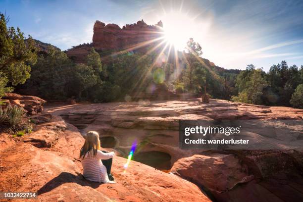 girl sitting at seven sacred pools, sedona - sightseeing in sedona stock pictures, royalty-free photos & images