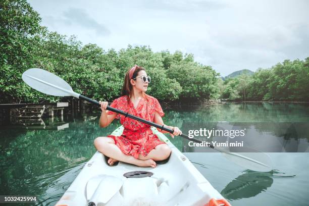 Asian woman with Kayaks in Beautiful mangrove forest Lagoon vacation time