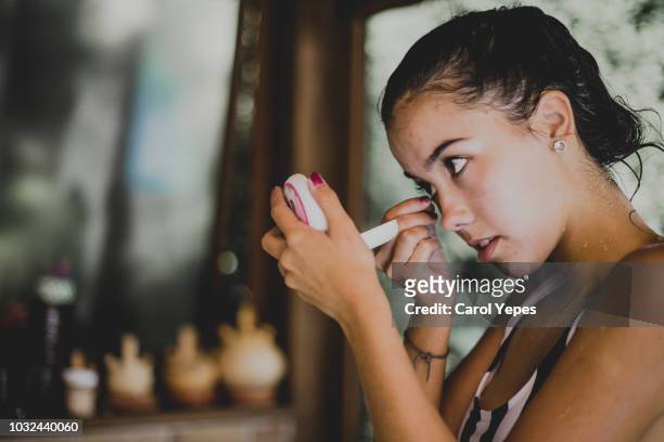 woman  removing contact lenses - lente a contatto foto e immagini stock