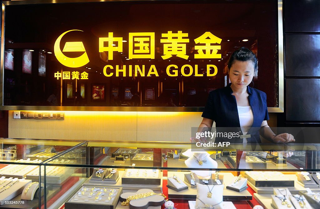A Chinese worker waits for customers at