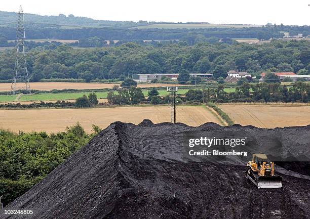 Caterpillar Inc. Bulldozer sits on top of a pile of coal at the Thoresby colliery operated by U.K. Coal Plc., in Mansfield, U.K., on Wednesday, Aug...