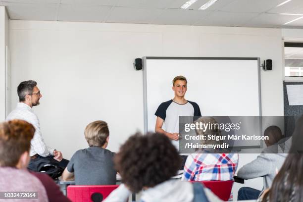 student giving presentation in classroom at class - boy giving speech stock pictures, royalty-free photos & images