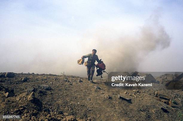 Mortar shell explodes behind an Iranian Revolutionary Guard who was helping members of the press with their equipment in Al-Fao Peninsula, Iraq, 15th...