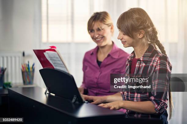 teenage girl doing musical school homework - practicing piano stock pictures, royalty-free photos & images