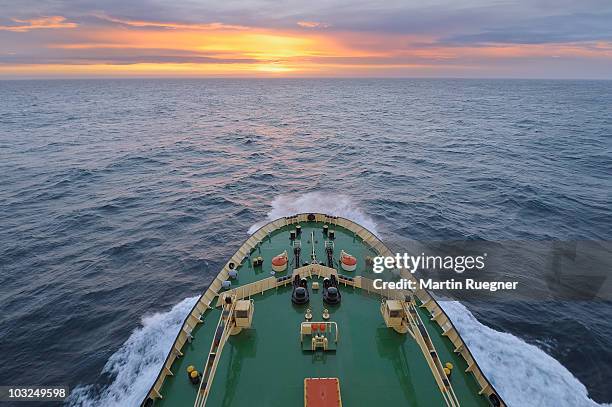 bow of icebreaker in open sea at the way to sunset - ships bow stock pictures, royalty-free photos & images