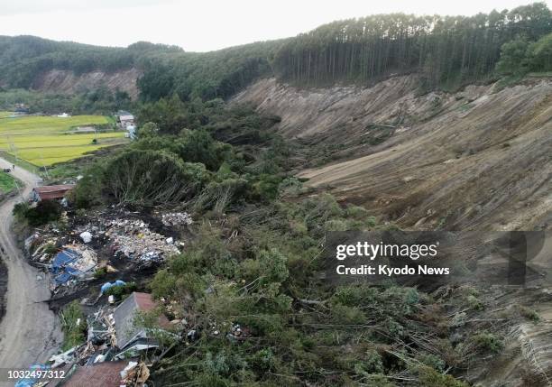 Photo taken Sept. 12 from a drone shows houses in Atsuma, Hokkaido, leveled by a landslide following the Sept. 6 earthquake that struck Japan's...