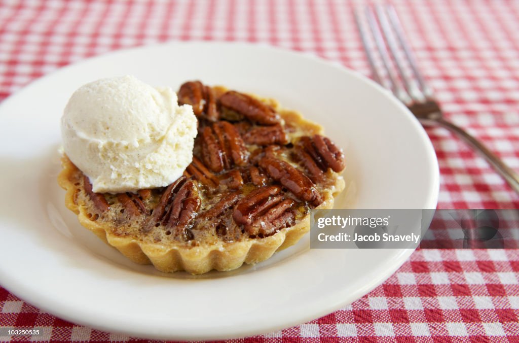 Single serving pecan pie with icecream.