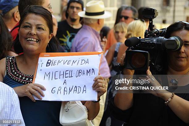 Woman holds a placard welcoming US First Lady Michelle Obama near Granada's cathedral on August 5 where Michelle Obama arrived for a visit. US First...