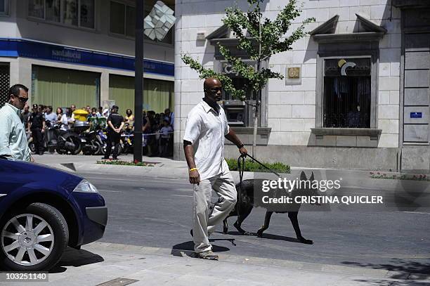 Security members walk a dog around Granada's cathedral where US First Lady Michelle Obama arrived for a visit, on August 5, 2010. US First Lady...