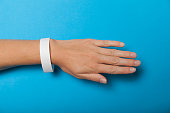 Paper wristband mockup, event bracelet on hand. Empty ticket wrist band design