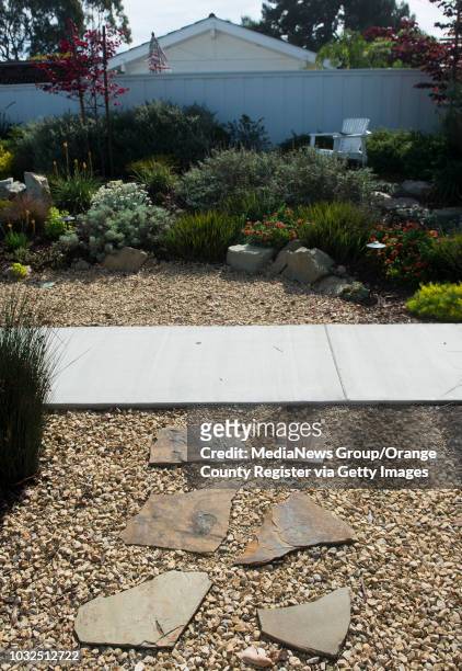 Stepping stones and a gravel covered drainage ditch as just a few of the elements in Mia Alexis' drought-resistant, California-friendly Newport Beach...