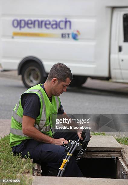 Chris Eldridge, an engineer for BT Openreach part of the BT Group Plc works on underground fibre optic cabling in Enfield, U.K., on Thursday, Aug. 5,...