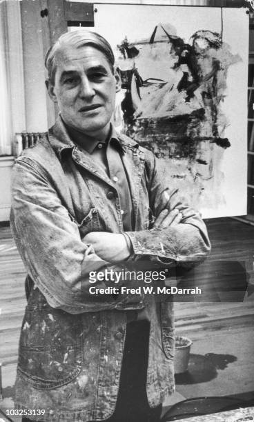 Portrait of Dutch American artist Willem de Kooning as he poses in his loft studio with his arms crossed, New York, New York, March 23, 1962.