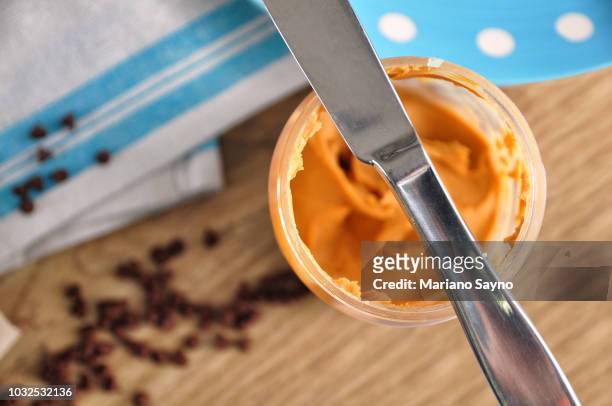 directly above shot of peanut butter in blue table napkin with peanuts - nut butter stock pictures, royalty-free photos & images