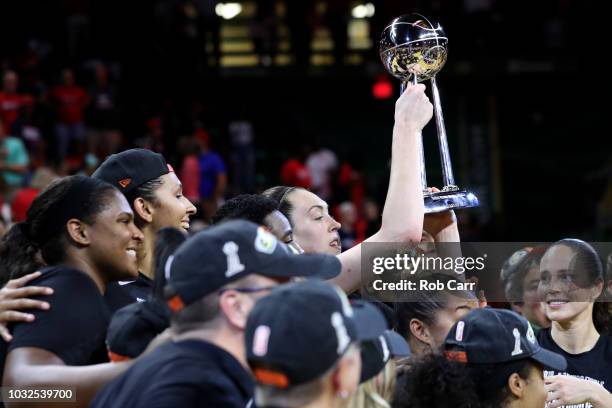 Breanna Stewart of the Seattle Storm holds up the trophy after the Storm defeated the Washington Mystics 98-82 to win the WNBA Finals at EagleBank...