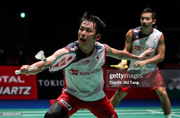 Takeshi Kamura and Keigo Sonoda of Japan compete in the Men's Doubles second round match against Kim Won Ho and Seo Seung Jae of Korea on day three...