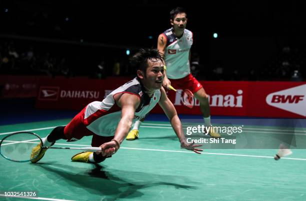 Takeshi Kamura and Keigo Sonoda of Japan compete in the Men's Doubles second round match against Kim Won Ho and Seo Seung Jae of Korea on day three...