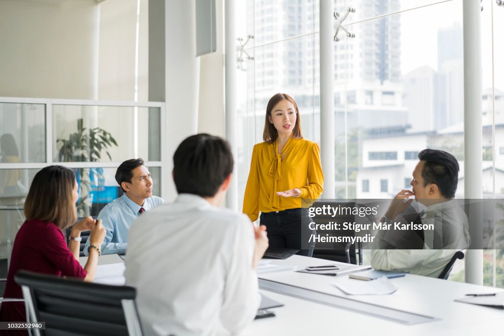 Businesswoman giving presentation in board room