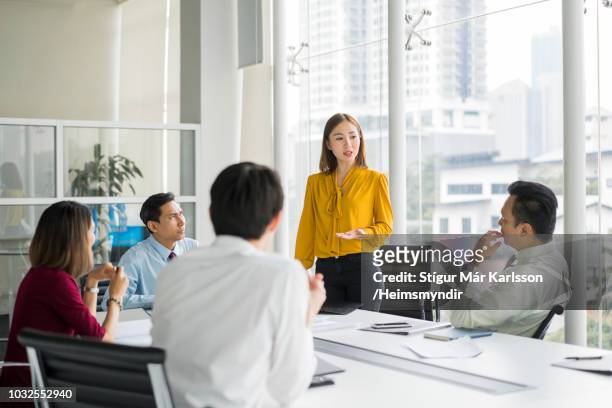 businesswoman giving presentation in board room - asia stock pictures, royalty-free photos & images