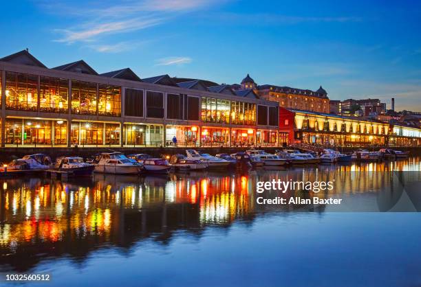 the redeveloped watershed district of bristol illuminated at dusk - bristol skyline stock pictures, royalty-free photos & images
